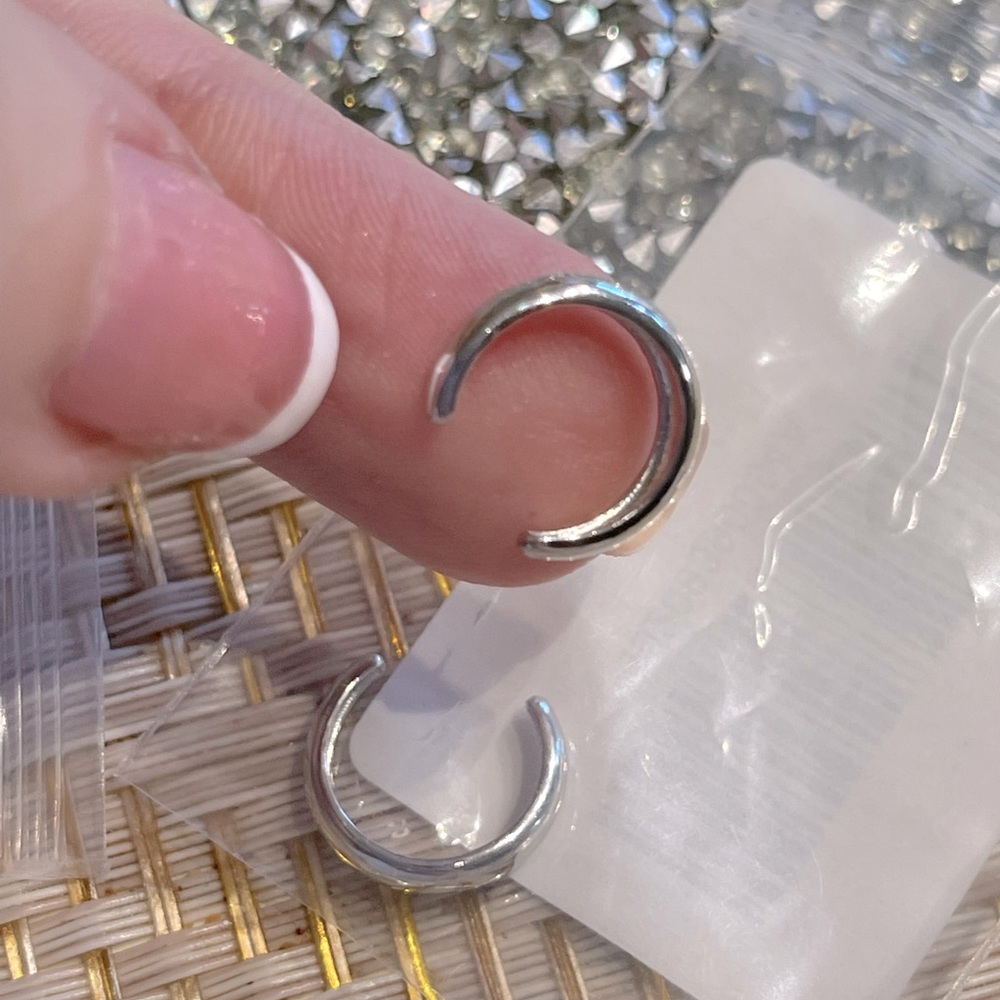 Two ear cuffs, silver color. Each cuff in a separate bag.